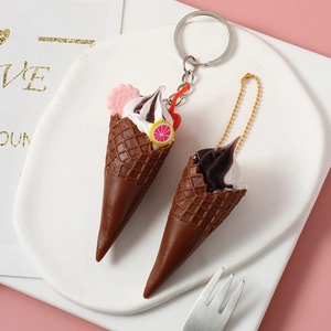Realistic mini ice cream cone keychain with chocolate drizzle and pink cookie detail