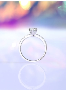 Detailed view of 925 silver ring with six-prong moissanite setting and side zircon accents