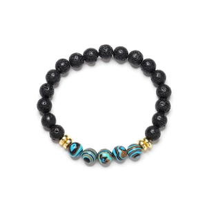 Lava stone bead bracelet with blue malachite accents and golden spacers on white background
