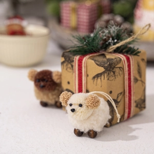 Detail of wool felt sheep ornaments with wooden beads and hanging strings for Christmas decor