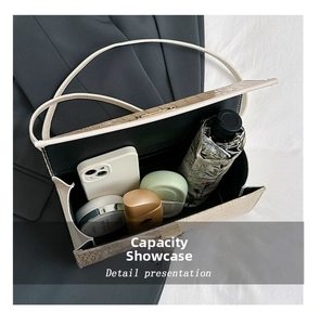 Detail presentation of cream crocodile pattern handbag with spacious interior capacity