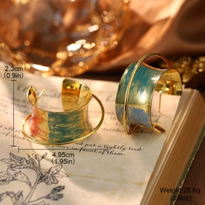 Artistic C-shape gold earrings with hand-painted blue and red textures on vintage book