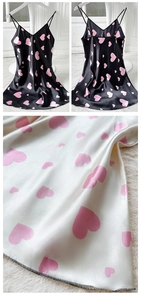 Detail of satin slip dress with heart print showing texture and strap design