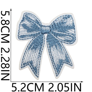 Detail of blue and white embroidered bow patch with measurement dimensions in inches