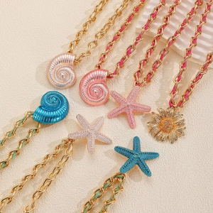 Colorful woven starfish and shell pendant necklaces on golden chunky metal chains