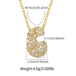 Detail of gold letter C pendant with zircon inlay and product size measurements