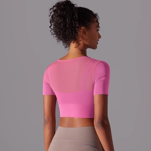 Rear view of pink crop top featuring breathable mesh paneling for fitness and yoga