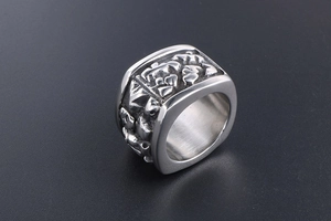 Macro detail of retro silver titanium steel wide ring featuring intricate 3D carved textures