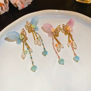 Elegant butterfly tassel earrings with pearls and crystals in a romantic aesthetic design