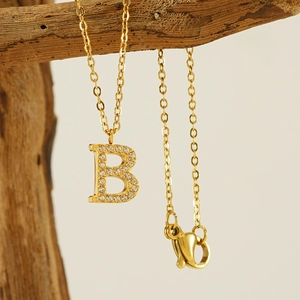 Golden titanium steel necklace featuring a crystal pavé letter B pendant on a branch
