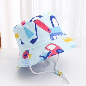 Detail of baby sun hat featuring blue excavator print and adjustable white wind rope