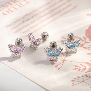 Silver butterfly cartilage earrings with pink and blue zircon stones in macro view