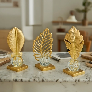 Three-piece gold crystal ball leaf ornaments on marble surface for home office decor
