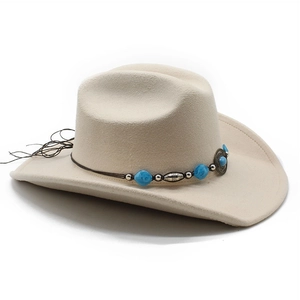 Detail of beige felt cowboy hat with turquoise beads and vintage silver metal ornaments