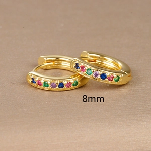 Detailed macro view of 8mm golden huggie earrings set with colorful rainbow zircon stones