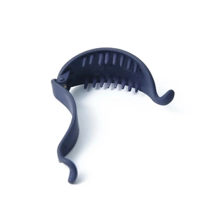 Matte dark blue banana hair clip with internal comb teeth shown on a white background