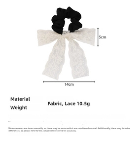 Detailed view of 10.5g lightweight French vintage black fabric scrunchie with white lace bow