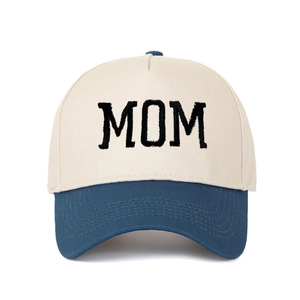 Close-up of MOM embroidery on a two-tone cotton canvas baseball cap with blue brim