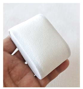 Close-up of white velvet watch pillow showing soft texture and rounded curved display design