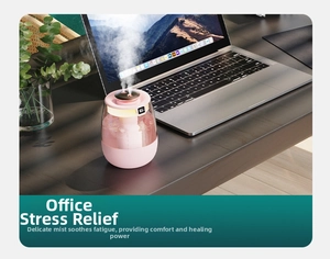 Pink dual mist humidifier with LED display showing humidity level on wooden desk