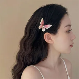 Elegant vintage butterfly hair clip with pink gradient wings and pearl pendant detail