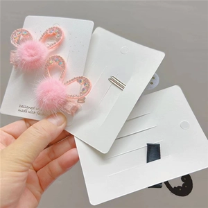 Detailed view of pink faux fur bunny ear hair clips with sparkling rhinestone accents