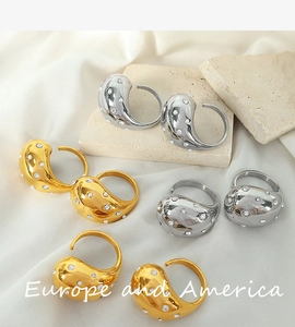 Detailed close-up of 18K gold and silver chunky dome rings with micro-inlaid rhinestones