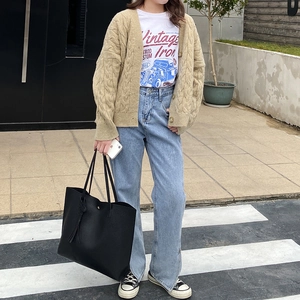 Chic street style look featuring a large black pebbled leather tote bag with casual outfit