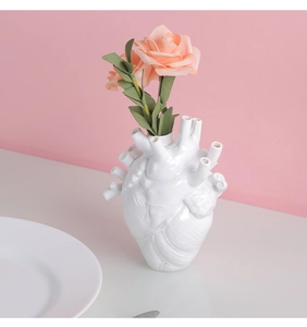 Detailed macro view of white anatomical heart ceramic vase with textured muscle fibers