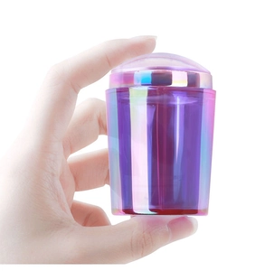 Iridescent purple silicone nail stamper with clear lid held in hand for French tips