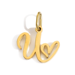 Macro detail of gold U-letter pendant featuring a minimalist heart symbol