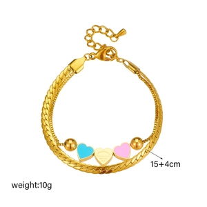 Double-layered golden bracelet with blue and pink heart charms and bead accents