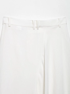 Detailed view of the linen blend white trousers waist featuring premium fabric texture