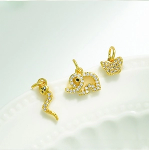 Macro shot of 18K gold plated animal pendants with micro-pave white zircon details