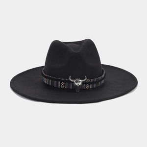 Detail of black felt fedora featuring a colorful ethnic woven band and silver bull skull buckle
