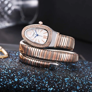 Detail of snake-shaped watch with crystal bezel and rose gold silver metallic strap