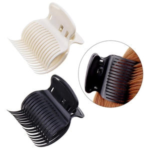 Salon hair roller clips in black and cream white colors for professional hair styling