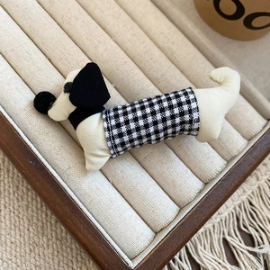 Detailed view of handmade polka dot fabric dachshund dog hair clip on display