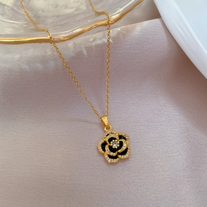 Detailed close-up of golden camellia flower pendant with micro-inlaid rhinestones
