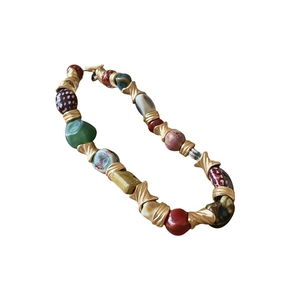 Vintage-style beaded necklace with colorful ceramic stones and gold twisted metal spacers