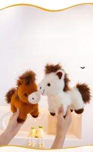 Close-up of soft plush white and brown pony dolls with fluffy manes and tails