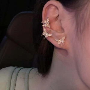 Elegant butterfly ear cuff set with shiny rhinestones worn on the earlobe and cartilage