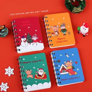 Set of four colorful Christmas spiral notebooks with cartoon holiday illustrations