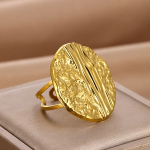 Close-up of golden irregular hammer texture surface on adjustable geometric ring