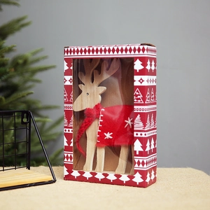 Christmas wooden reindeer decoration with red scarf in a festive window gift box