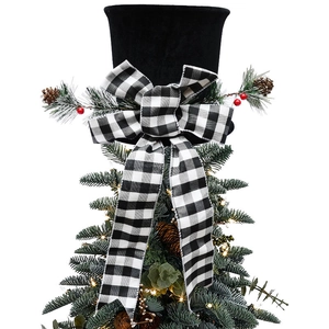 Detail of black velvet Christmas tree topper hat with plaid bow and pine cone accents