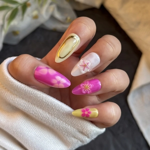 Elegant almond press-on nails with 3D floral relief and gold wire detailing in pink tones