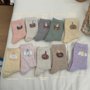 Detail of grid layout showing various colors of speckled yarn cartoon bear socks