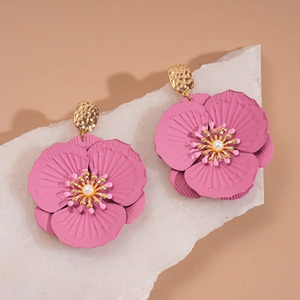 Detail of pink painted flower earrings with gold hammered metal and white pearl center