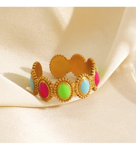 Detail of gold-plated open ring featuring colorful oval enamel inlays and beaded edges